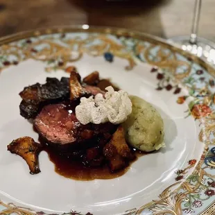 a plate of food with a glass of wine