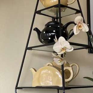 a shelf with teapots and teapots