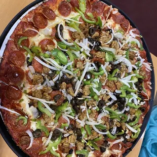 Supreme Pizza minus mushrooms and added black olives.