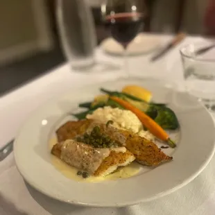 a plate of food and a glass of wine