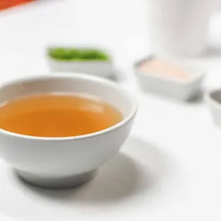 a bowl of soup and a plate of meat