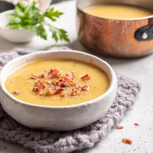 a bowl of soup with bacon
