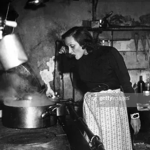 a woman cooking in a kitchen