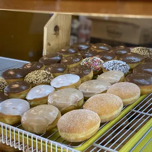 a variety of doughnuts in a display case
