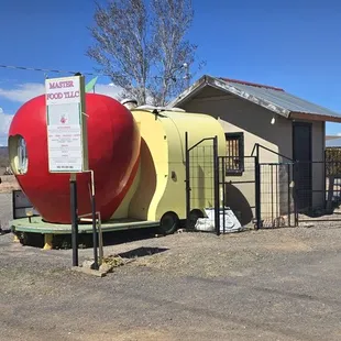 Cute little food truck stall with parking and seating in the background