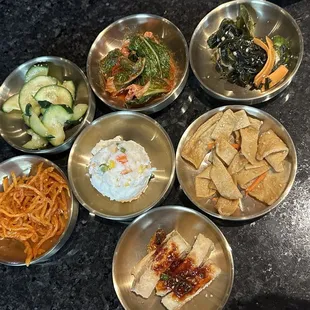 Banchan: squid, mashed potatoes, cucumber, kimchi, seaweed, fish cake, and fried tofu
