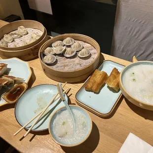 Vegetable dumplings, Xiaolongbao, Salted Chicken Congee with fried dough, and Chinese Style Pot Stickers