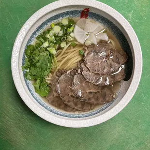 a bowl of beef and noodles