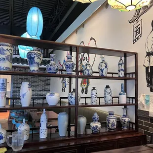a display of blue and white vases