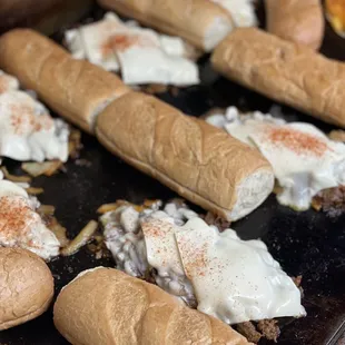 cheesesteaks on a baking sheet