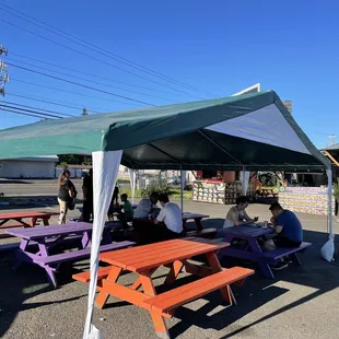 a group of people sitting under a tent