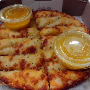 a pizza with cheese and mustard