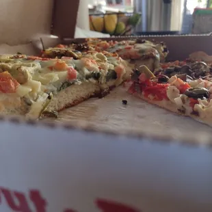 Detroit style pizza on the left, thin crust on the right. Detroit is about three times thicker.