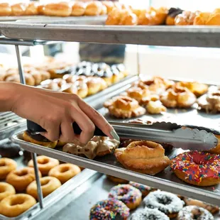 a person picking a donut