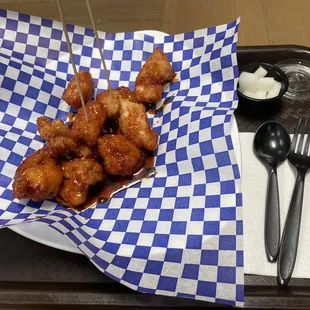 a tray of food with a fork and spoon