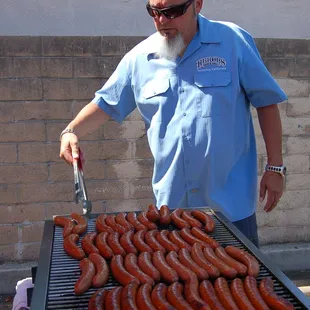 Billy from Heroes Bar &amp; Grill in DTF cooking up some tasty sausage at our 50th Anniversary Ribbon Cutting Ceremony.