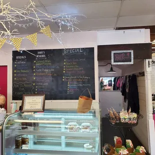 a bakery with a chalkboard menu on the wall