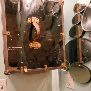 an old suitcase hanging on a wall