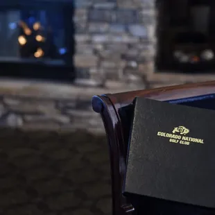 a table with a menu in front of a fireplace
