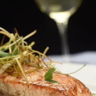 a plate of food and a glass of wine