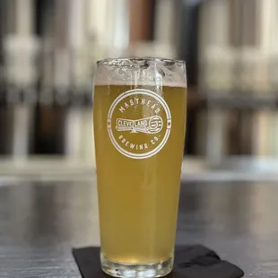 a glass of beer on a coaster