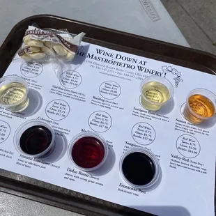 a tray of wine tasting samples