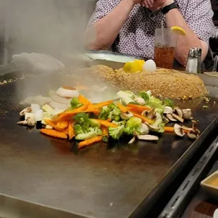 a man sitting in front of a grill