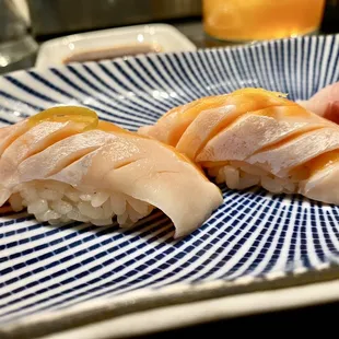 three different types of sushi on a blue and white plate