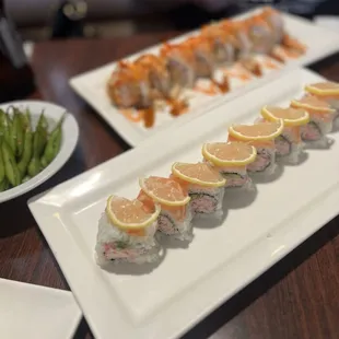 a plate of sushi and a plate of asparagus