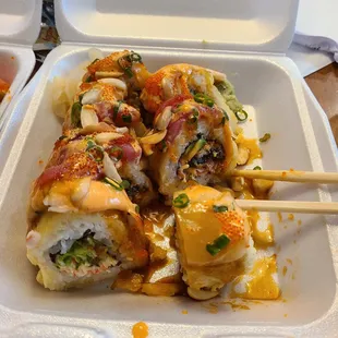 a sushi roll in a styrofoam container