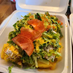 a salad in a styrofoam container