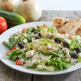 a plate of salad with pita bread