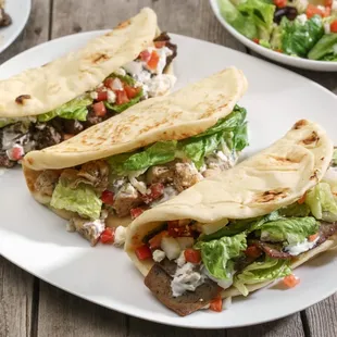a plate of tacos and a salad
