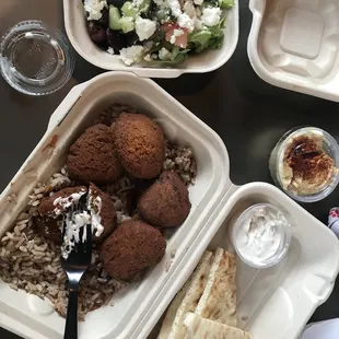Falafel platter including veggie rice, falafel, tzatziki sauce, pita and a small Grecian salad!