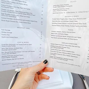 a person holding a menu at a restaurant