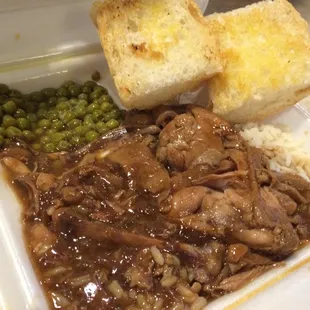 Stewed chicken over rice plate