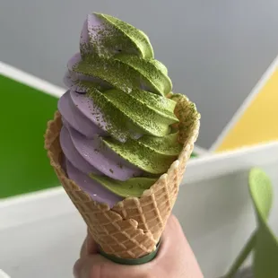 Ube matcha swirl soft serve in a waffle cone