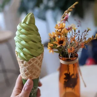 a hand holding an ice cream cone
