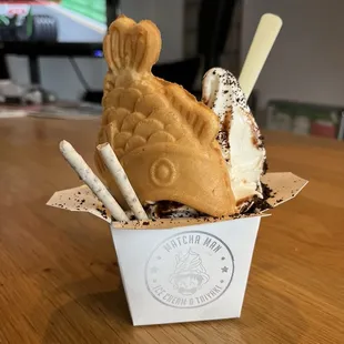 Salted caramel cake tayaki box with chocolate drizzle, Oreo crumble and pocky sticks