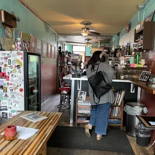 a woman standing in a coffee shop