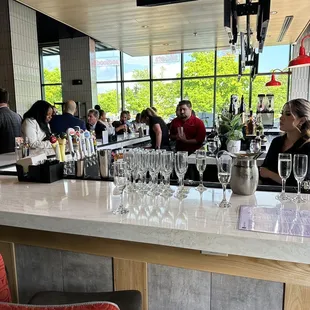 a group of people sitting at a bar