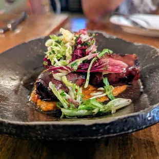 Datiles. $10. Goat cheese stuffed dates, crispy serrano ham, romesco.