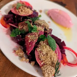 Remolacha. $14. Beet goat cheese mousse, spring onion, citrus roasted beets, benne brittle.