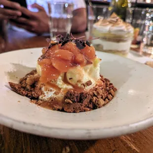 Basque Cheesecake. $10. Peach compote, Graham cracker streusel, peaches and cream cloud.