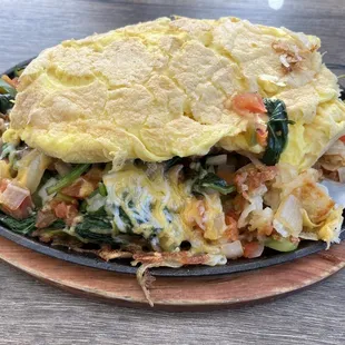 My dish with soggy hash browns on the bottom, veggies, and then the awkward slab of eggs on top. Tasted okay though!