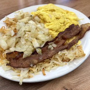 Scrambled eggs with hashbrowns, grilled onions and bacon.