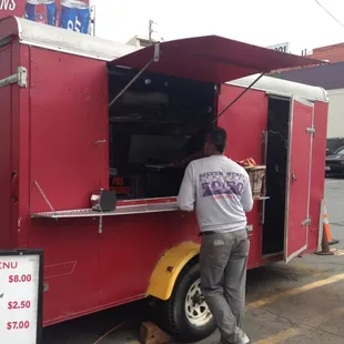 a man standing in front of a food truck