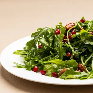 Verde -  Fresh-baby arugula, toasted almonds, pomegranate kernels, crispy pancetta, lemon vinaigrette