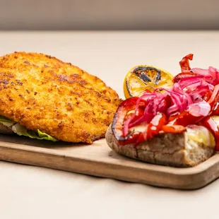 Chicken Pesto Milanese -
Pickled onions, provolone, roasted bell peppers, romaine lettuce