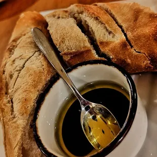 a plate of bread and a bowl of olive oil